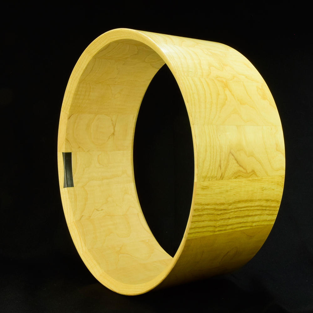 Ash stave snare drum shell in horizontal orientation