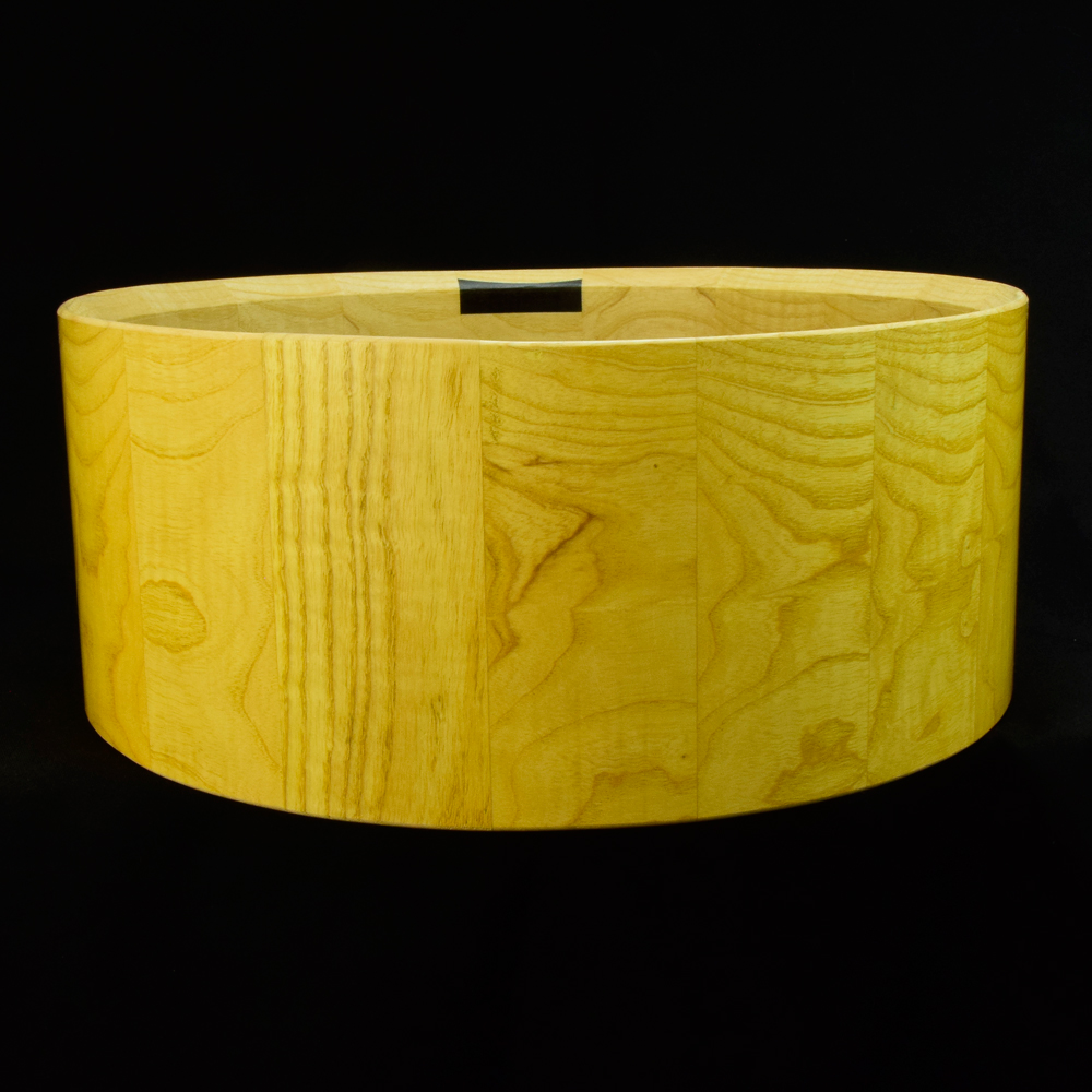 Ash stave snare drum shell in horizontal orientation