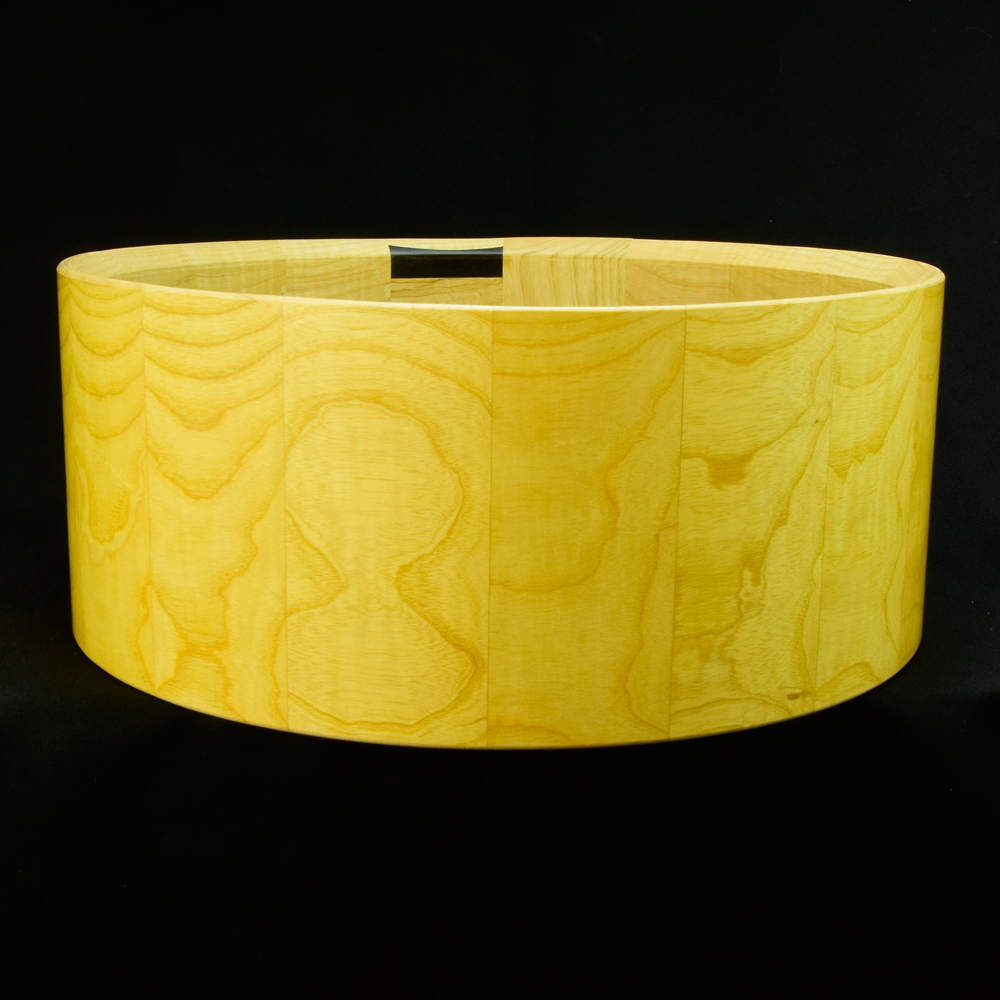 Ash stave snare drum shell in horizontal orientation