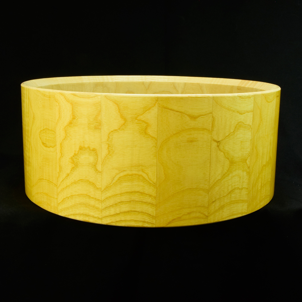 Ash stave snare drum shell in horizontal orientation