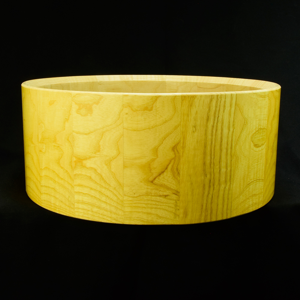 Ash stave snare drum shell in horizontal orientation