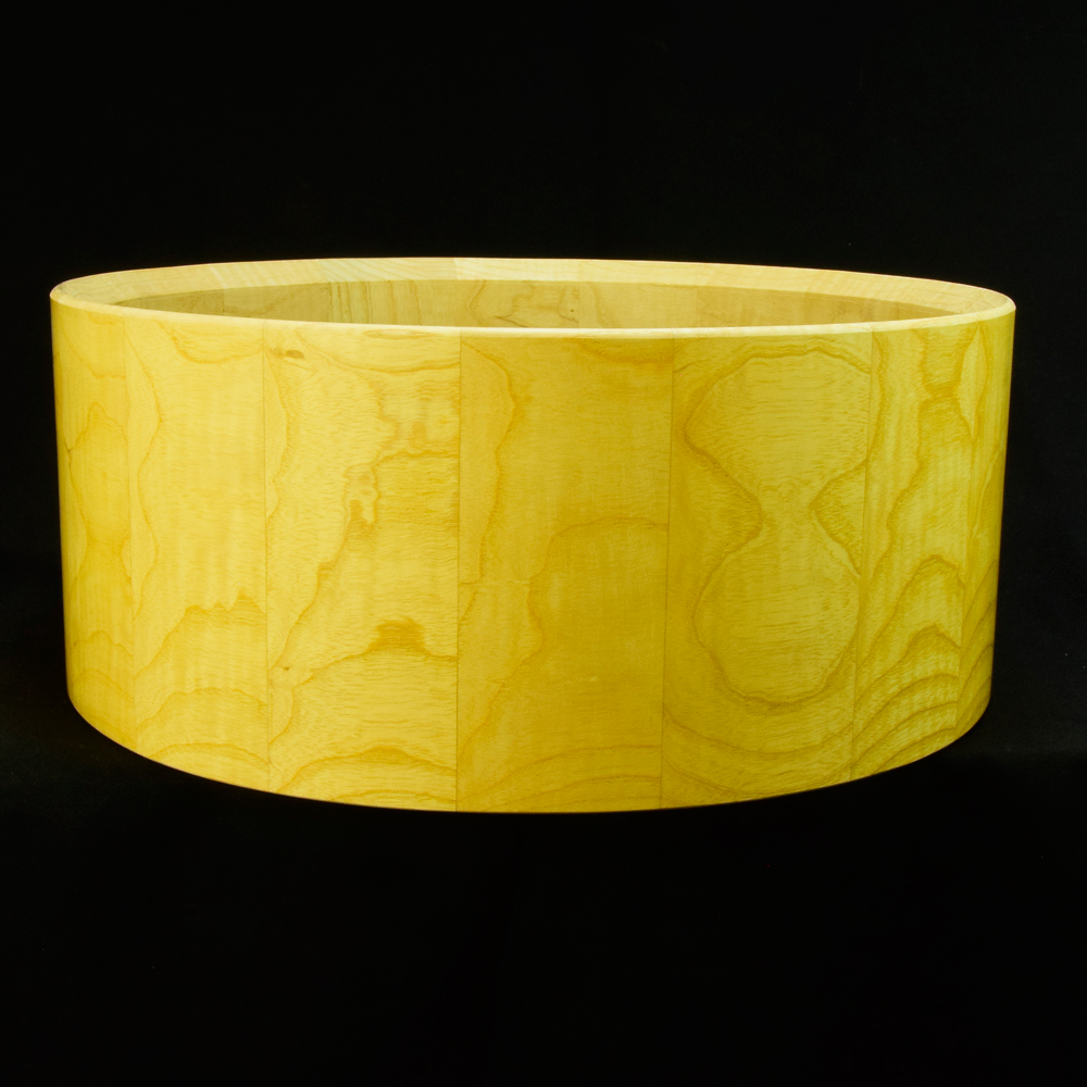 Ash stave snare drum shell in horizontal orientation