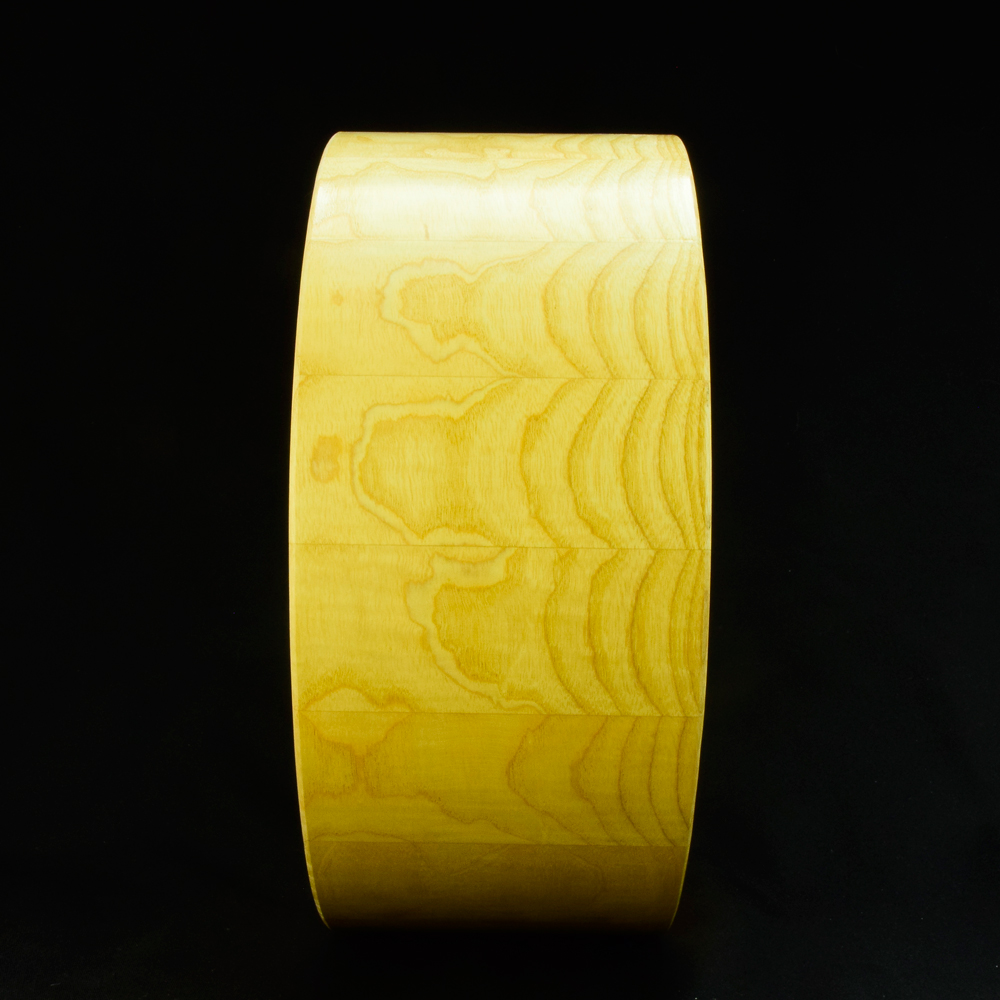 Ash stave snare drum shell in horizontal orientation